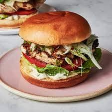 Image contains the picture of Grilled Chicken Bliss: Sunset Delight Sandwich.